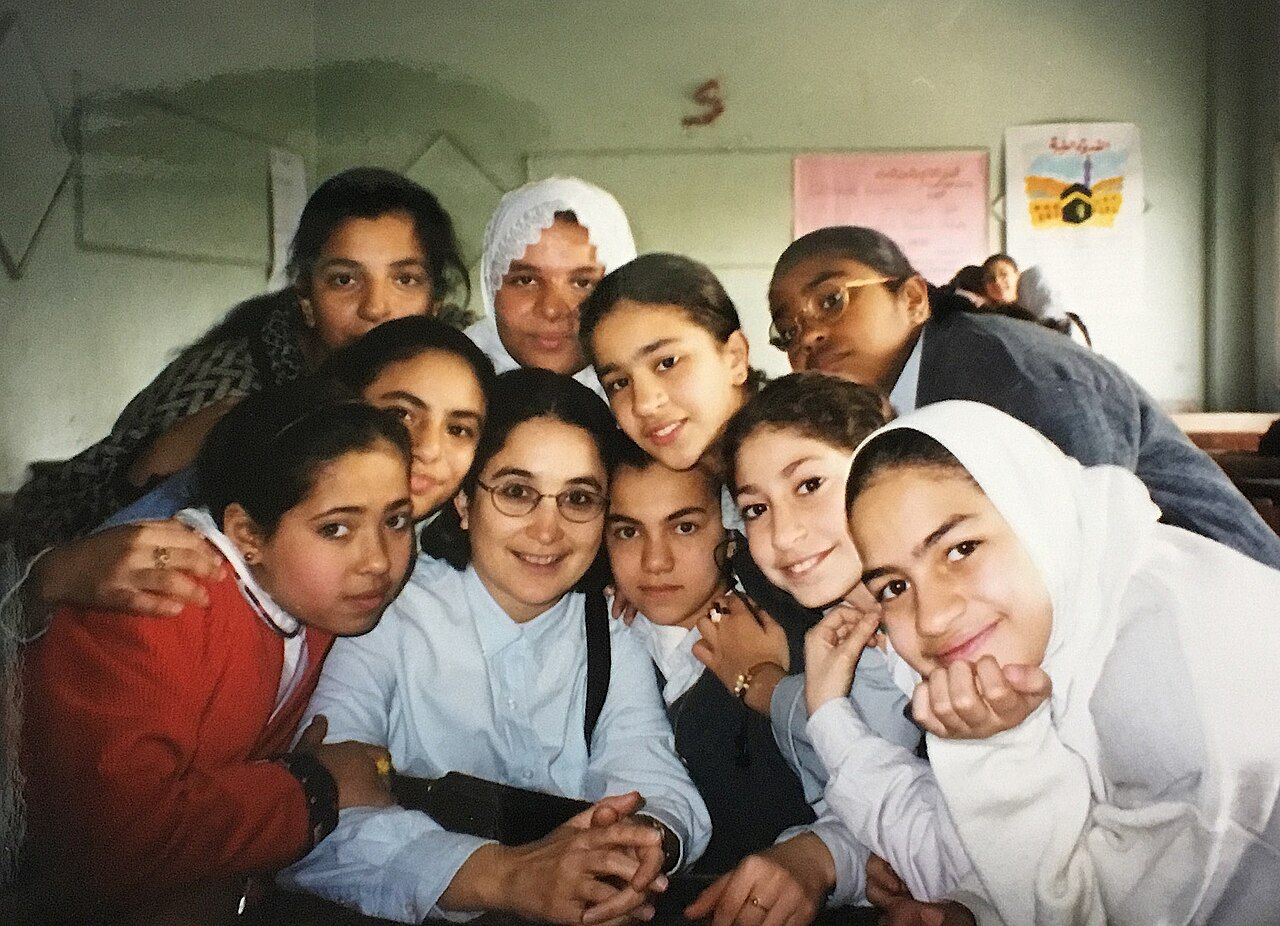 An anthropologist observing and taking part in daily life inside a classroom