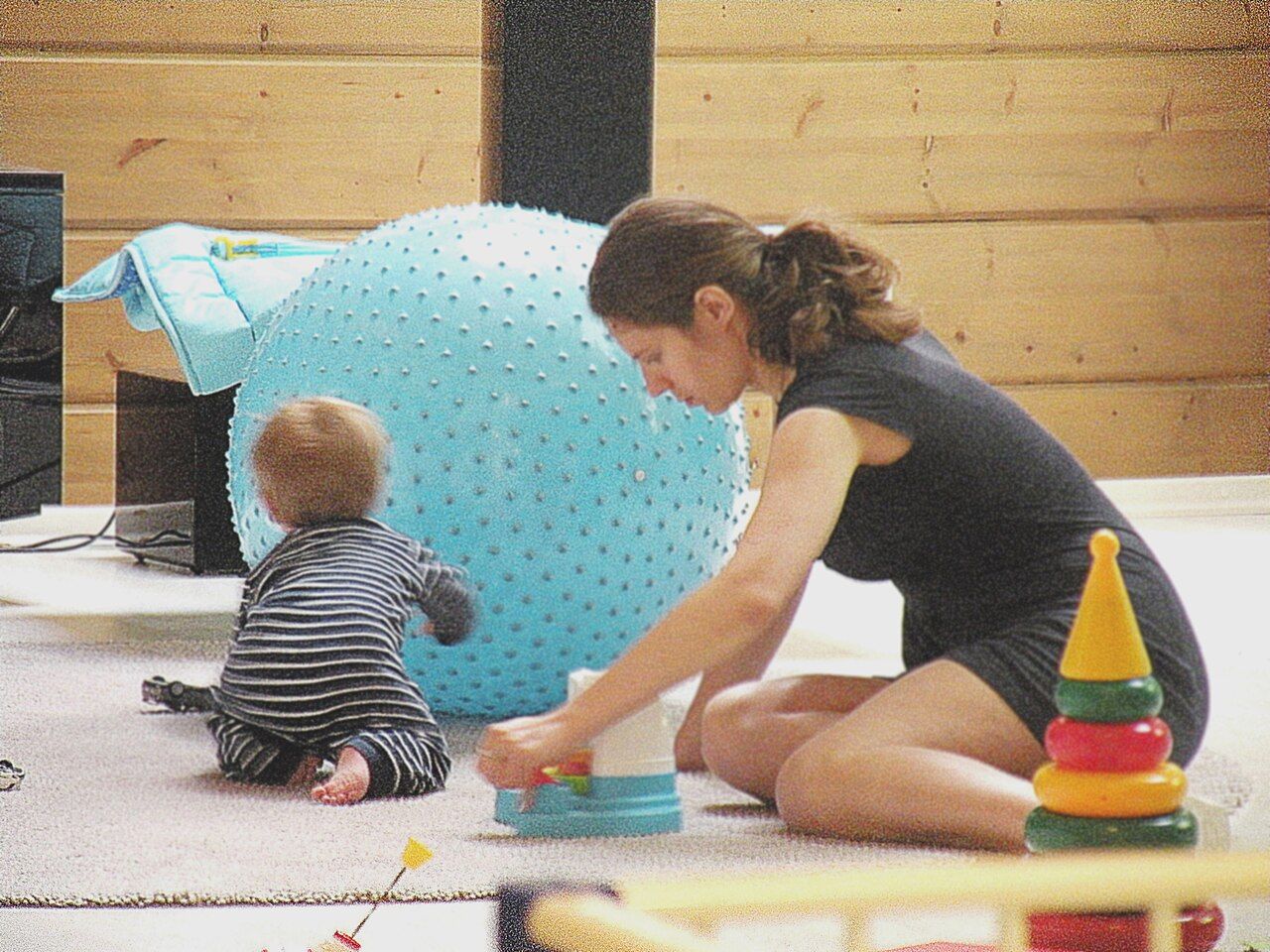 A mother holding and talking with her infant