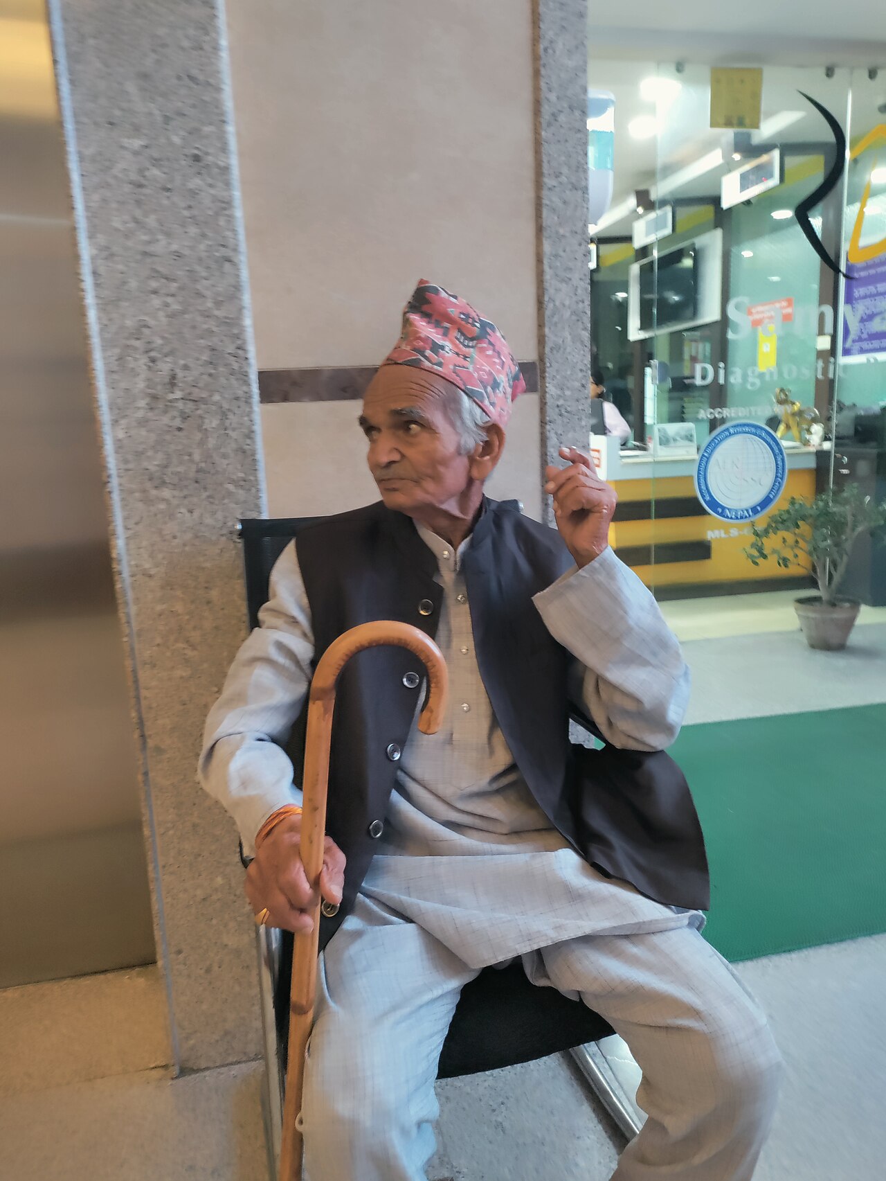 An older man walking with the aid of a stick