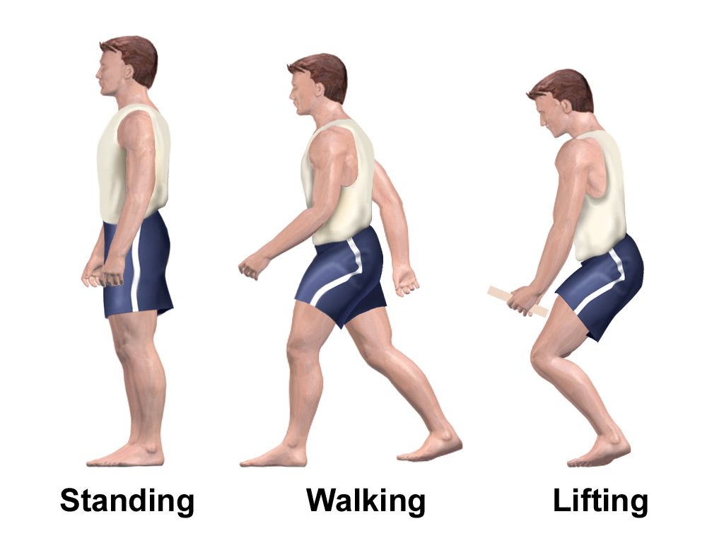 Close view of a caregiver holding a gait belt fastened around a patient's waist while the patient rises from a bed to standing