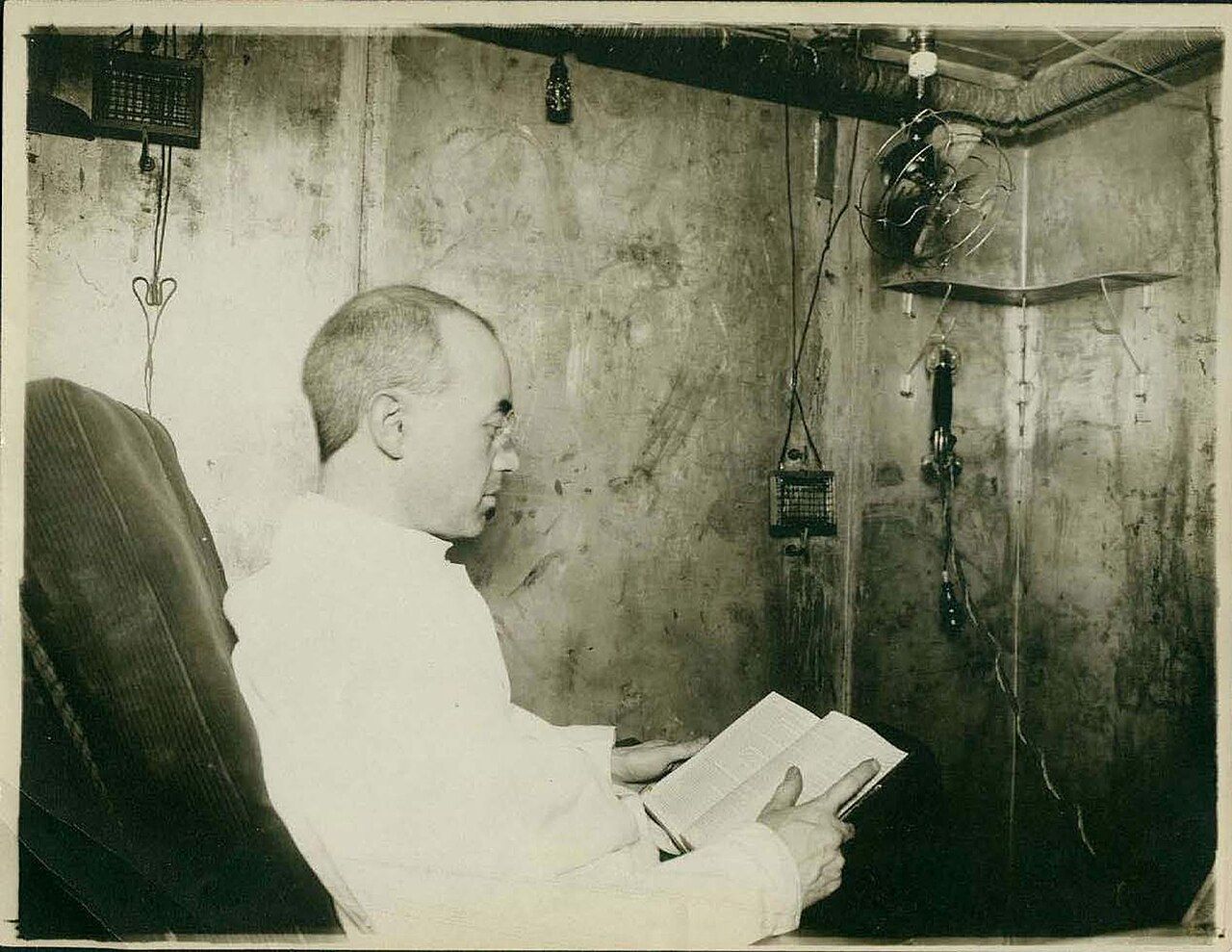 A person seated inside an early respiration calorimeter used to measure human energy expenditure