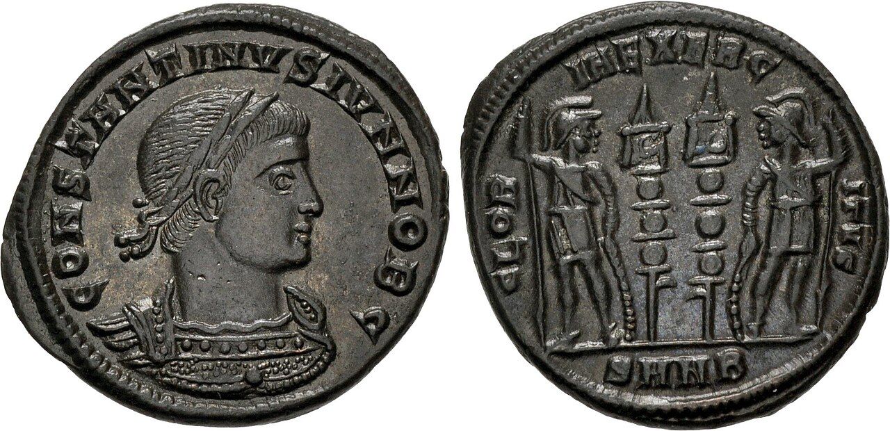 Two faces of a small bronze Roman coin: a diademed profile bust with the legend CONSTANTINVS IVN NOB C, and a reverse showing two helmeted soldiers flanking two military standards